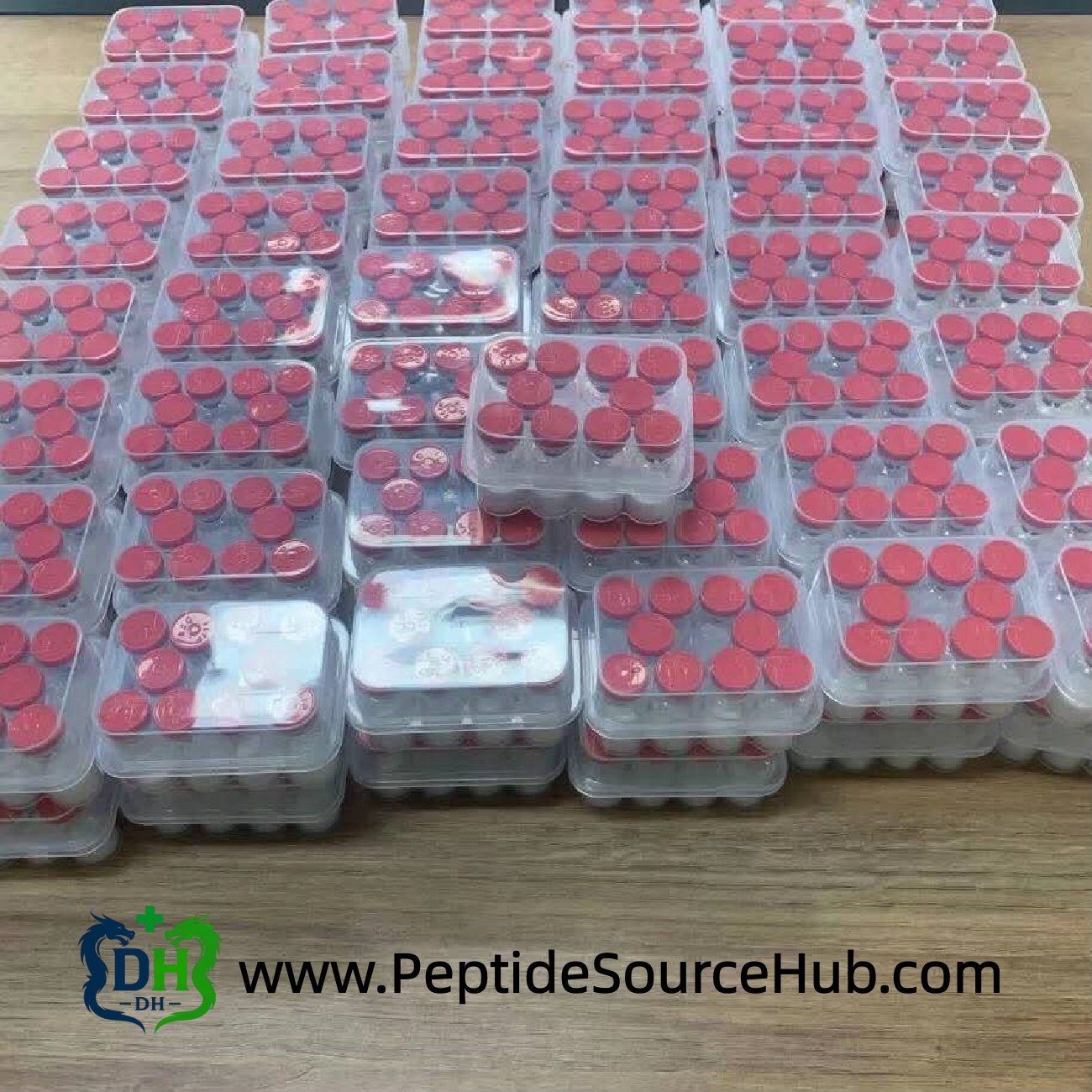 Bulk trays of peptide vials with red caps, factory packing