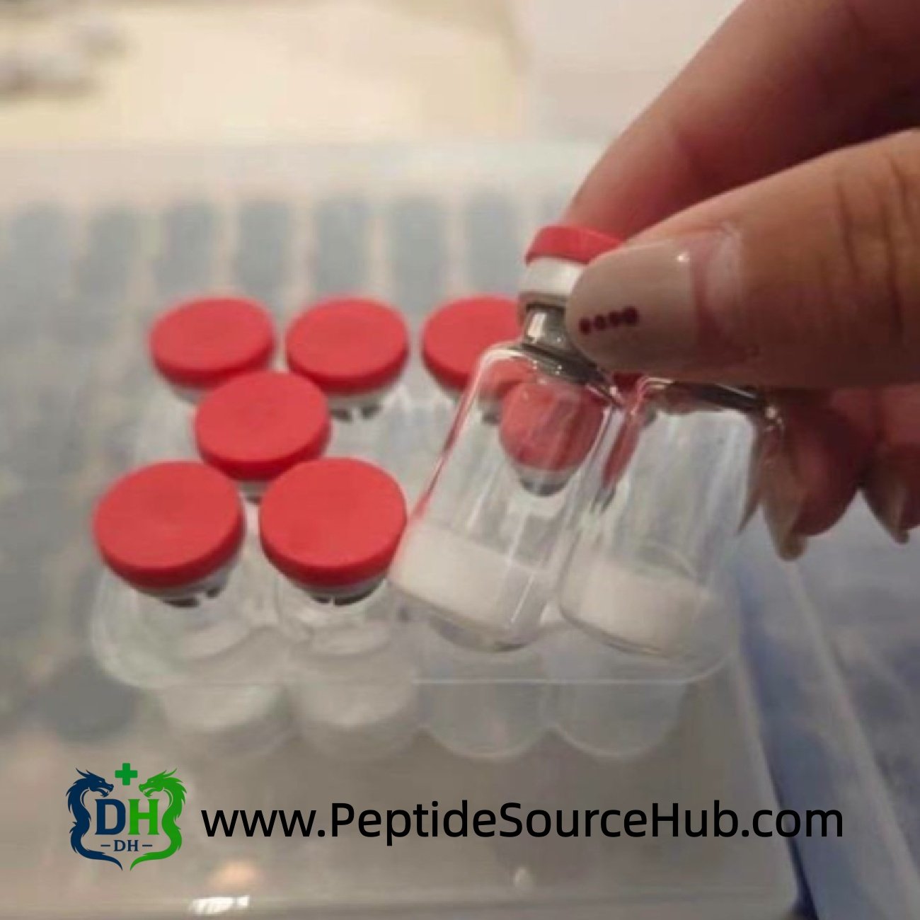 Hand holding two peptide vials with white lyophilized powder