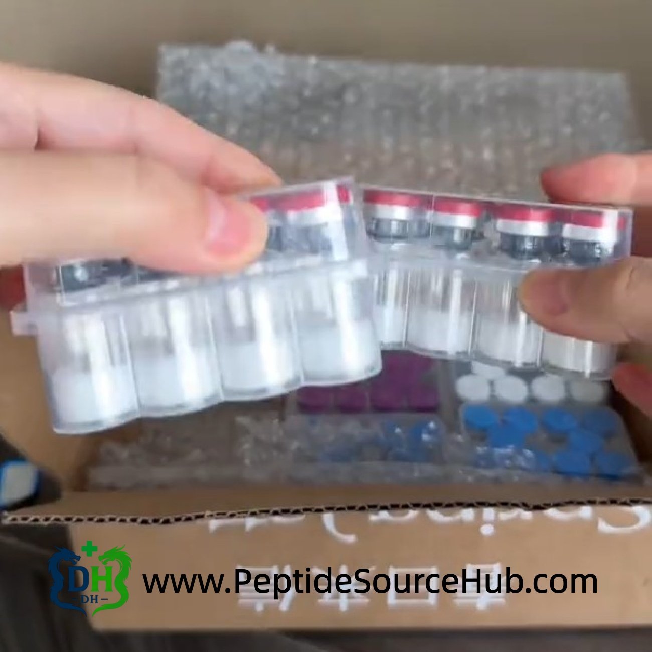 Peptide vial trays in an open carton, packing for shipping