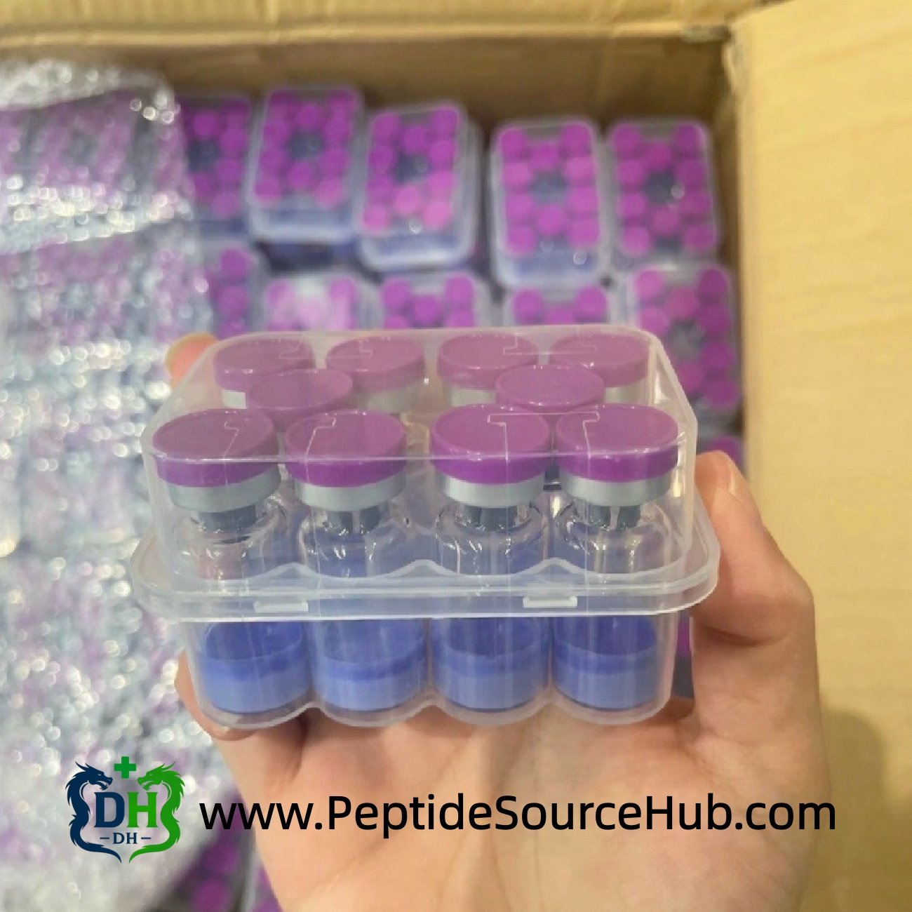 Hand holding purple cap Glow blue copper peptide tray