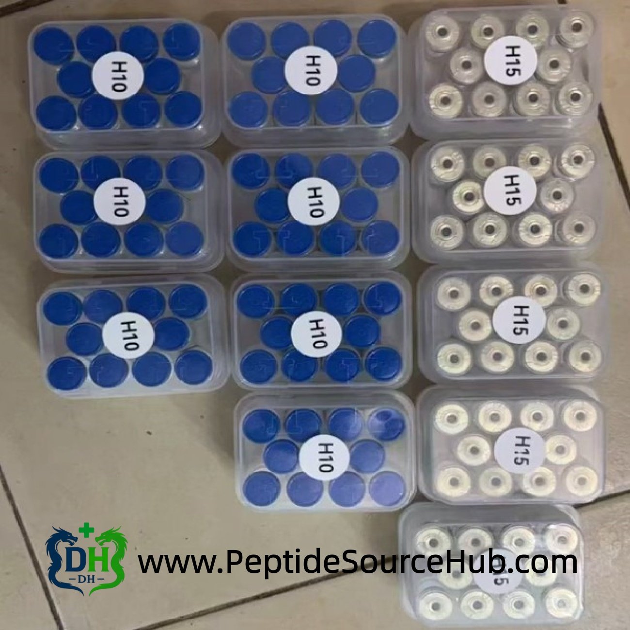 Top view of Custom-Dose HGH trays labeled H-15, showing organized batch coding and gold cap vials prepared for wholesale orders and OEM customers.