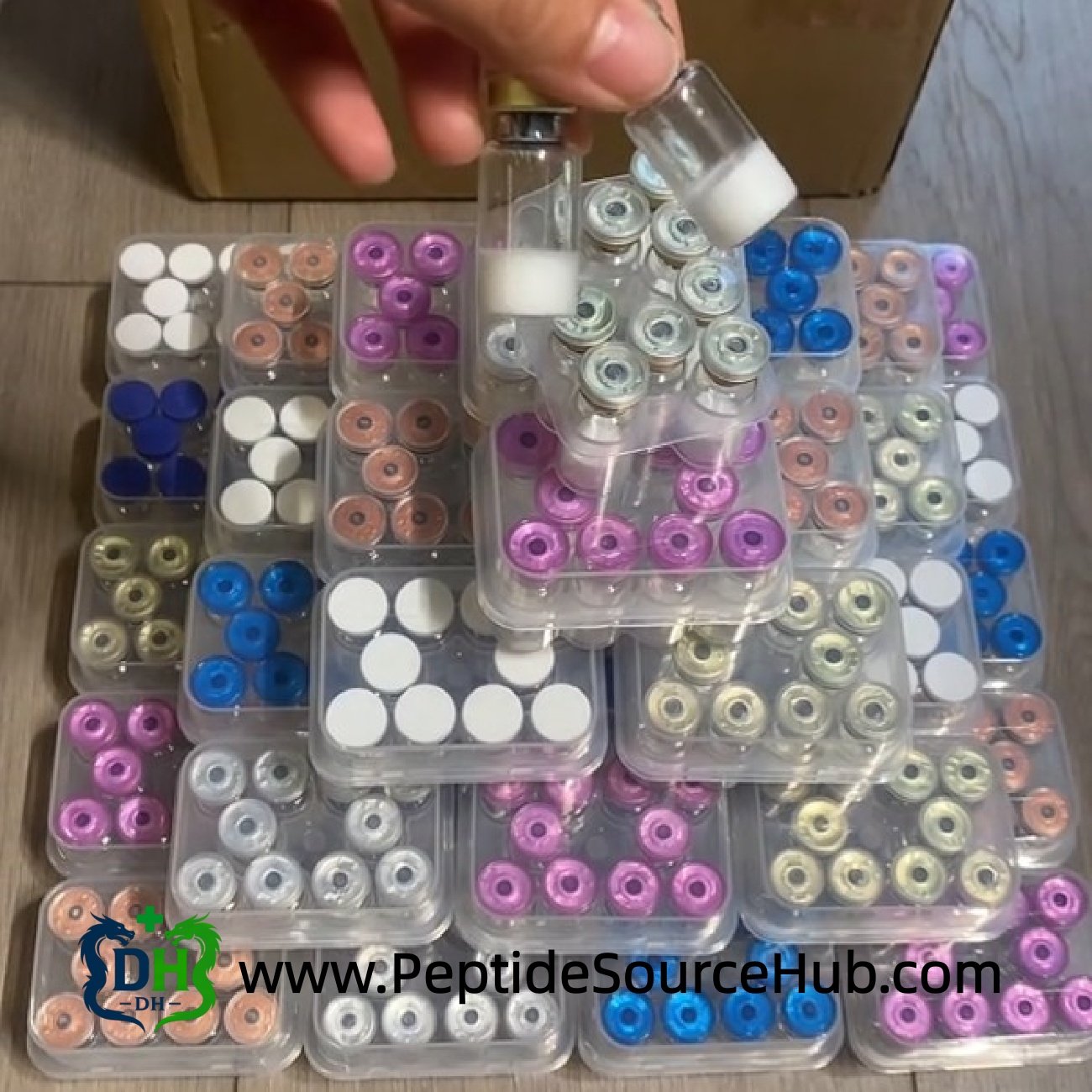 Custom HGH and peptide vials stacked in colorful cap pyramid