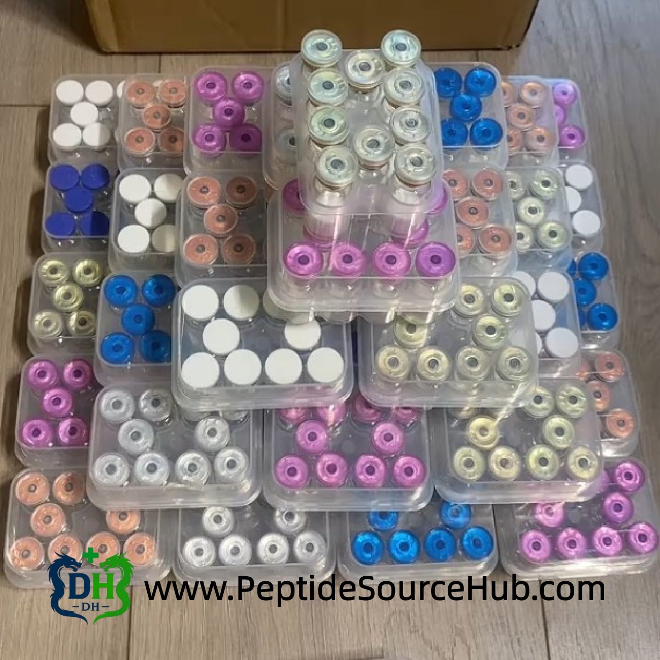 Multi-colour peptide vials stacked with HGH Fragment 176-191