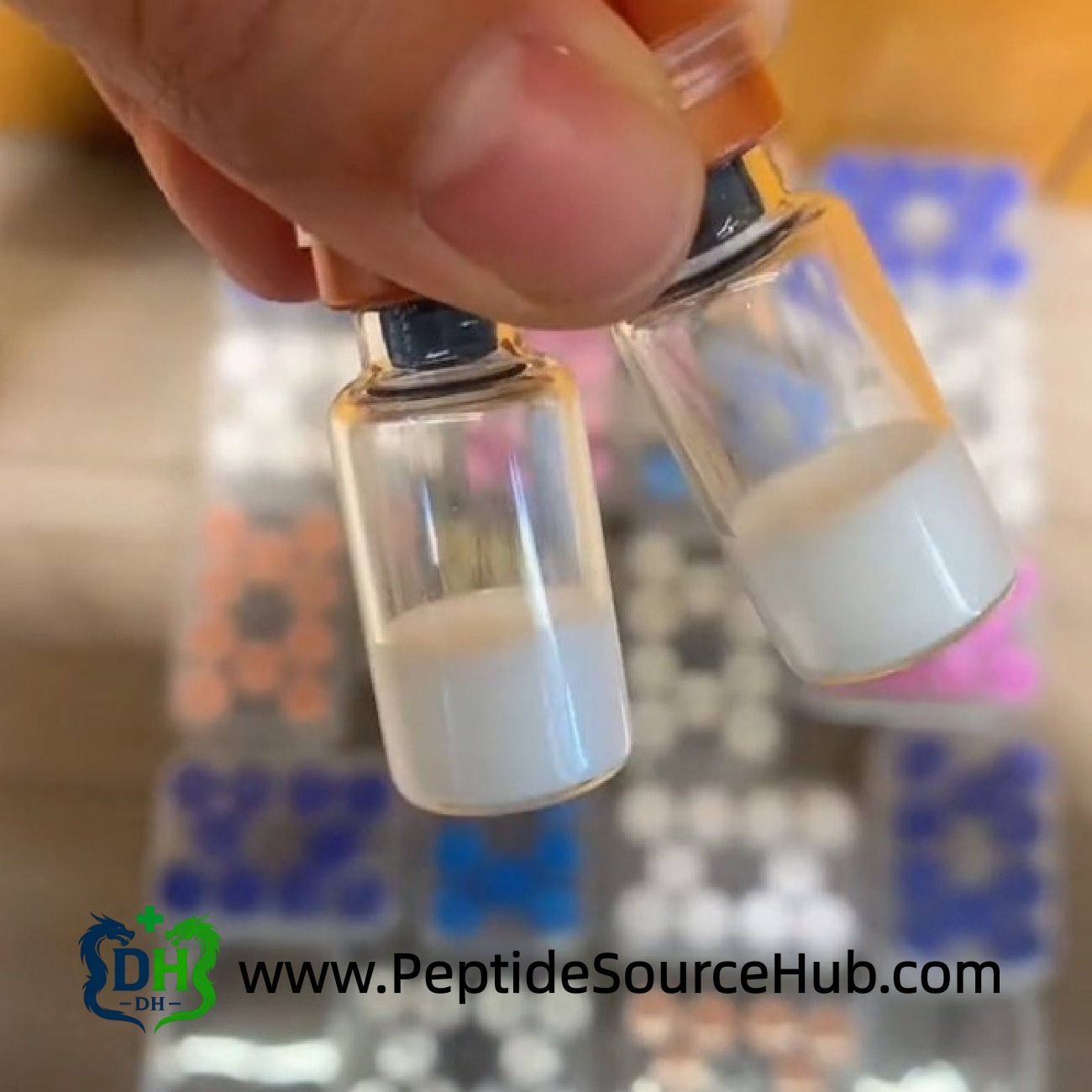 Two HGH Fragment 176-191 copper cap vials close-up