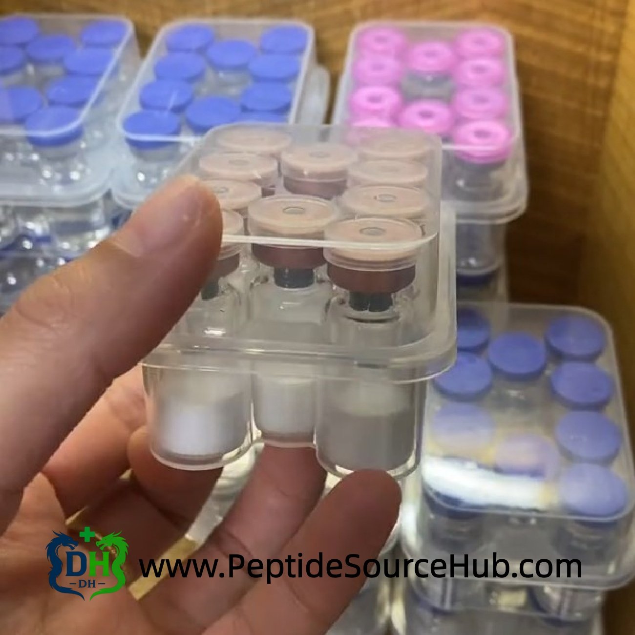 HGH Fragment 176-191 tray held in hand above bulk stock