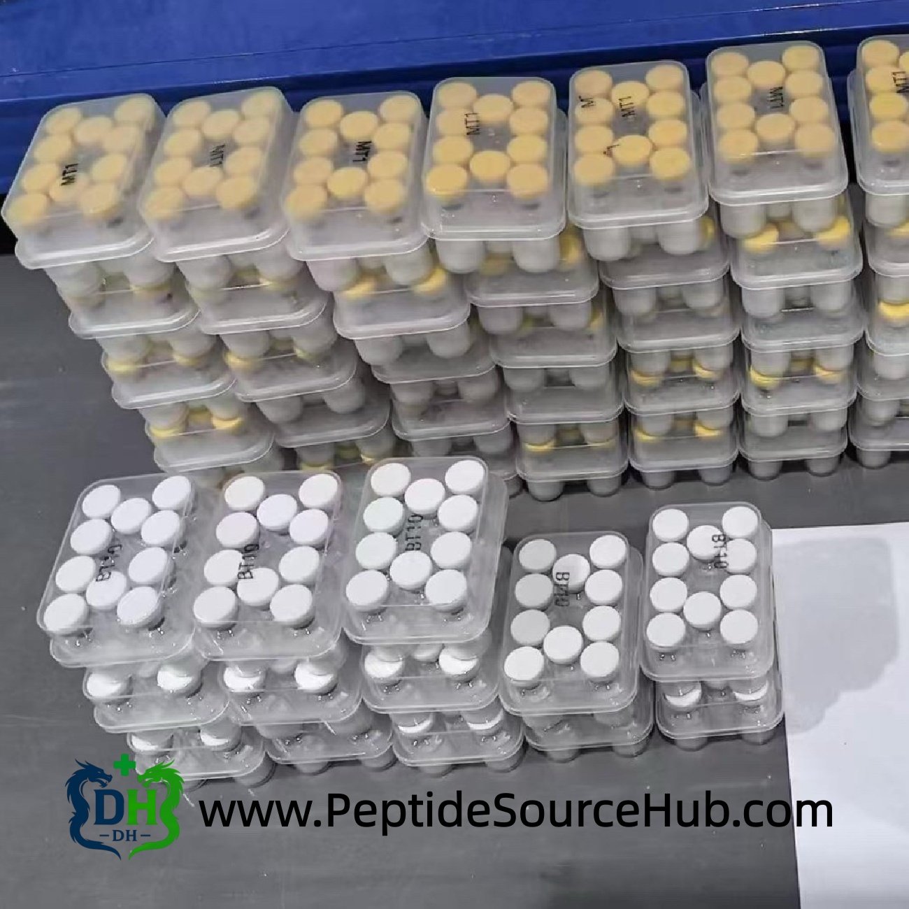 Stacked trays of Melanotan I MT1 10mg vials with yellow and white caps