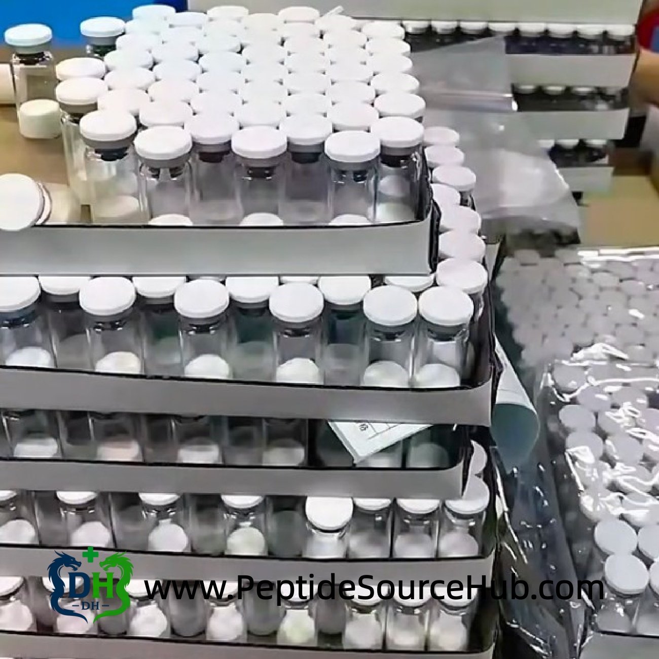 Large batches of white-capped peptide vials on production table