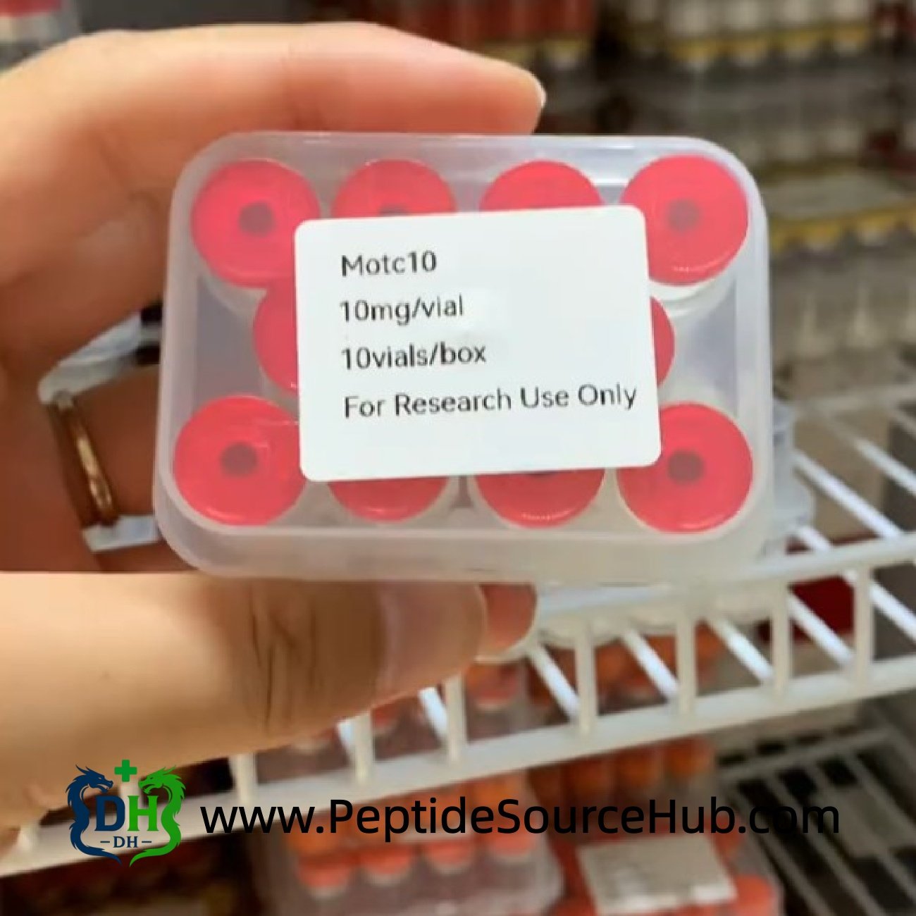 Hand holding MOTS-C 10 mg peptide tray with red caps