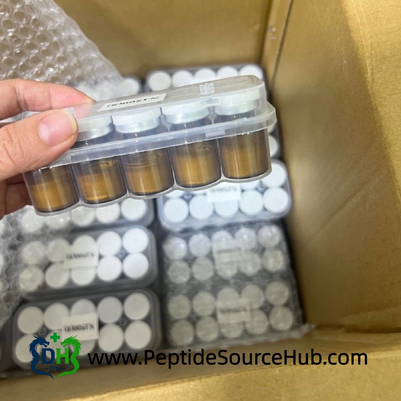 NAD+ amber vial tray above carton of white-cap vials