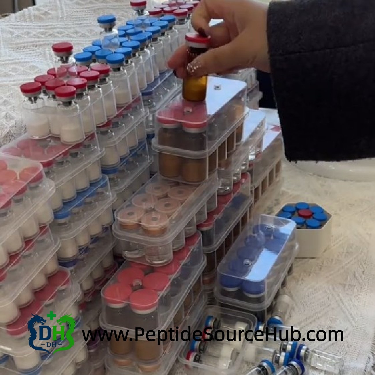 Display of mixed NAD+ and peptide vial trays on table