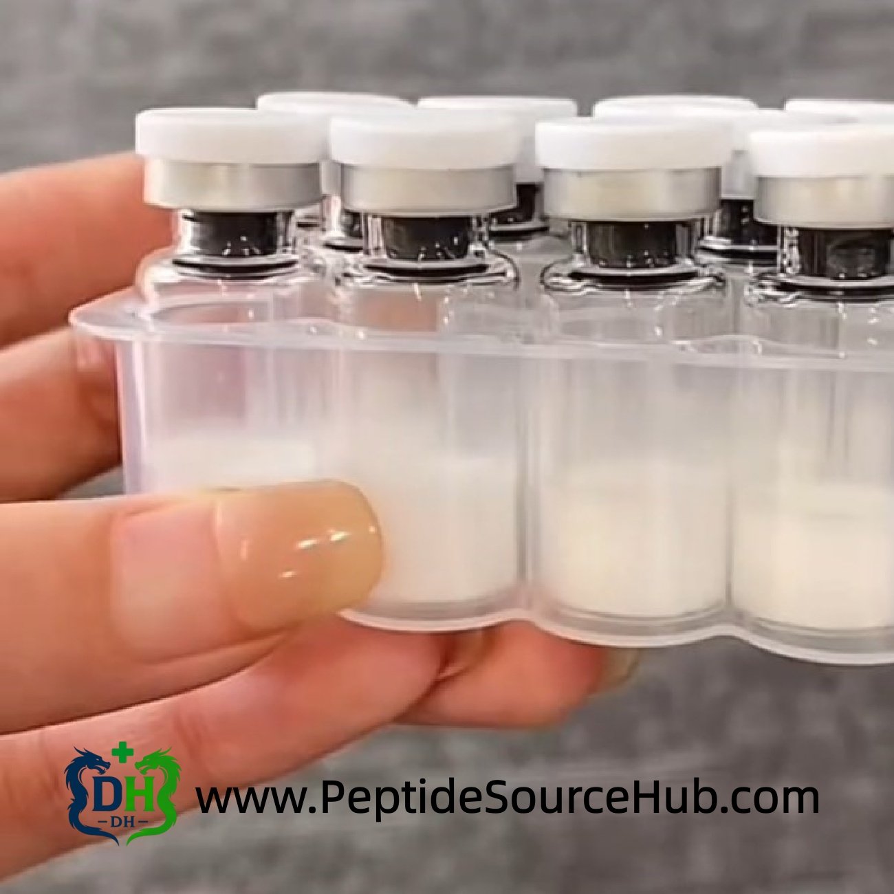 Tray of white-cap Oxytocin Acetate vials in hand