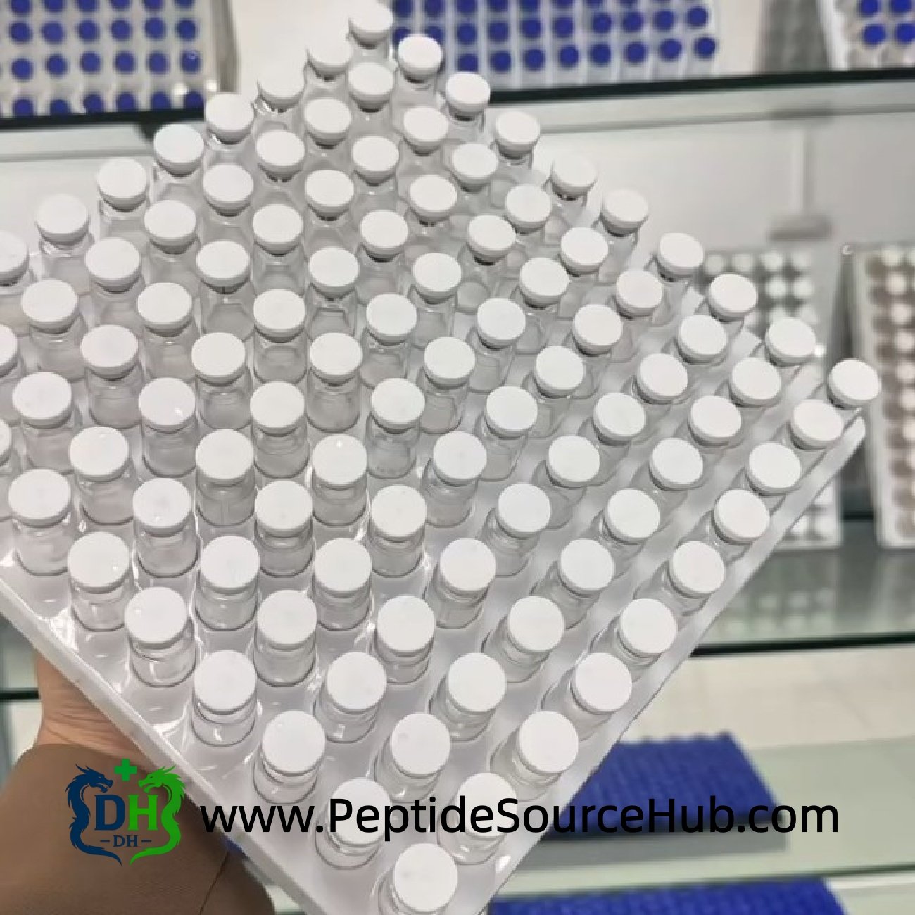 Multiple trays of white-cap peptide vials in rows