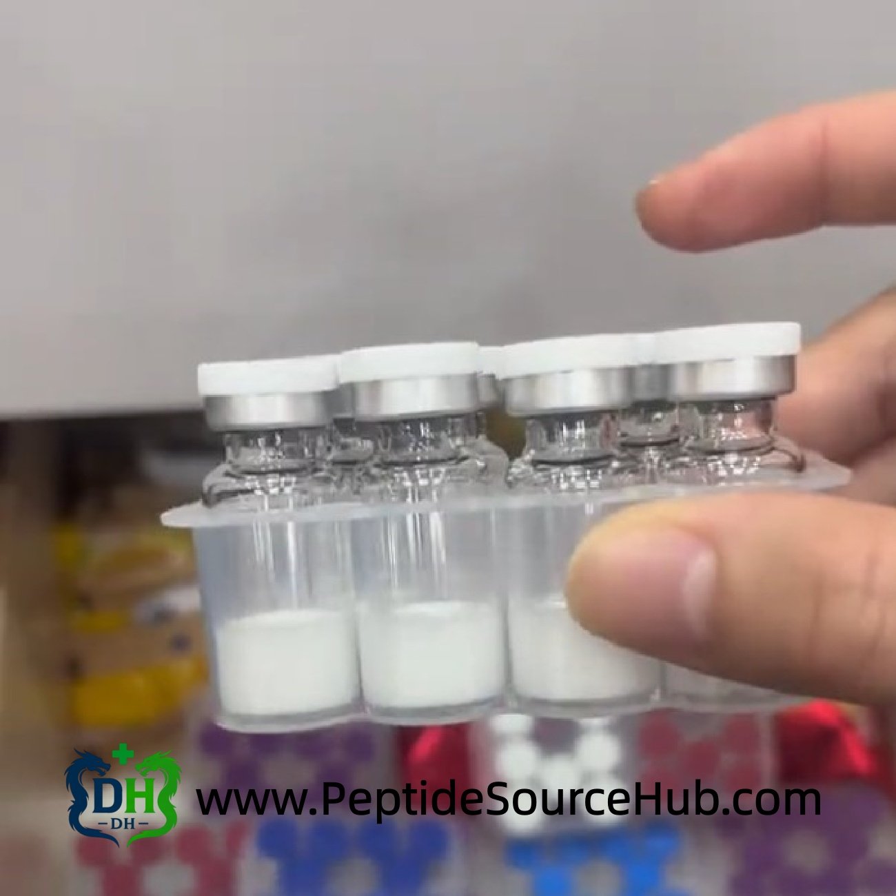 Hand holding SNAP-8 peptide 10 mg vials in plastic tray