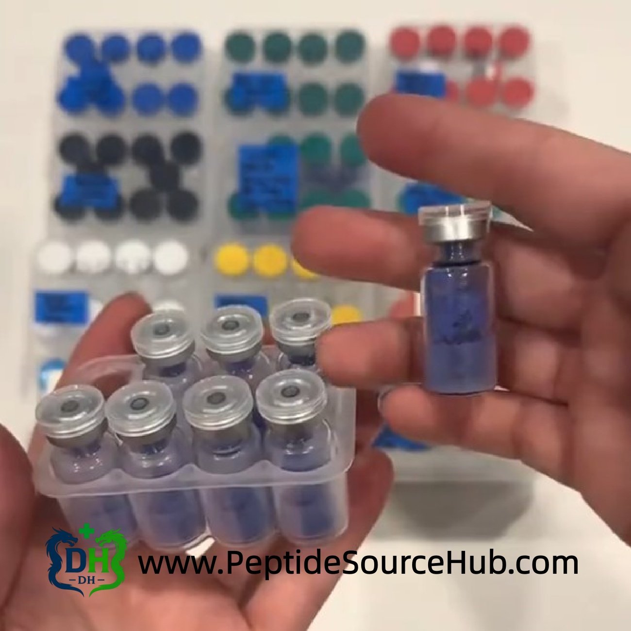Hands holding tray and single blue copper peptide vial