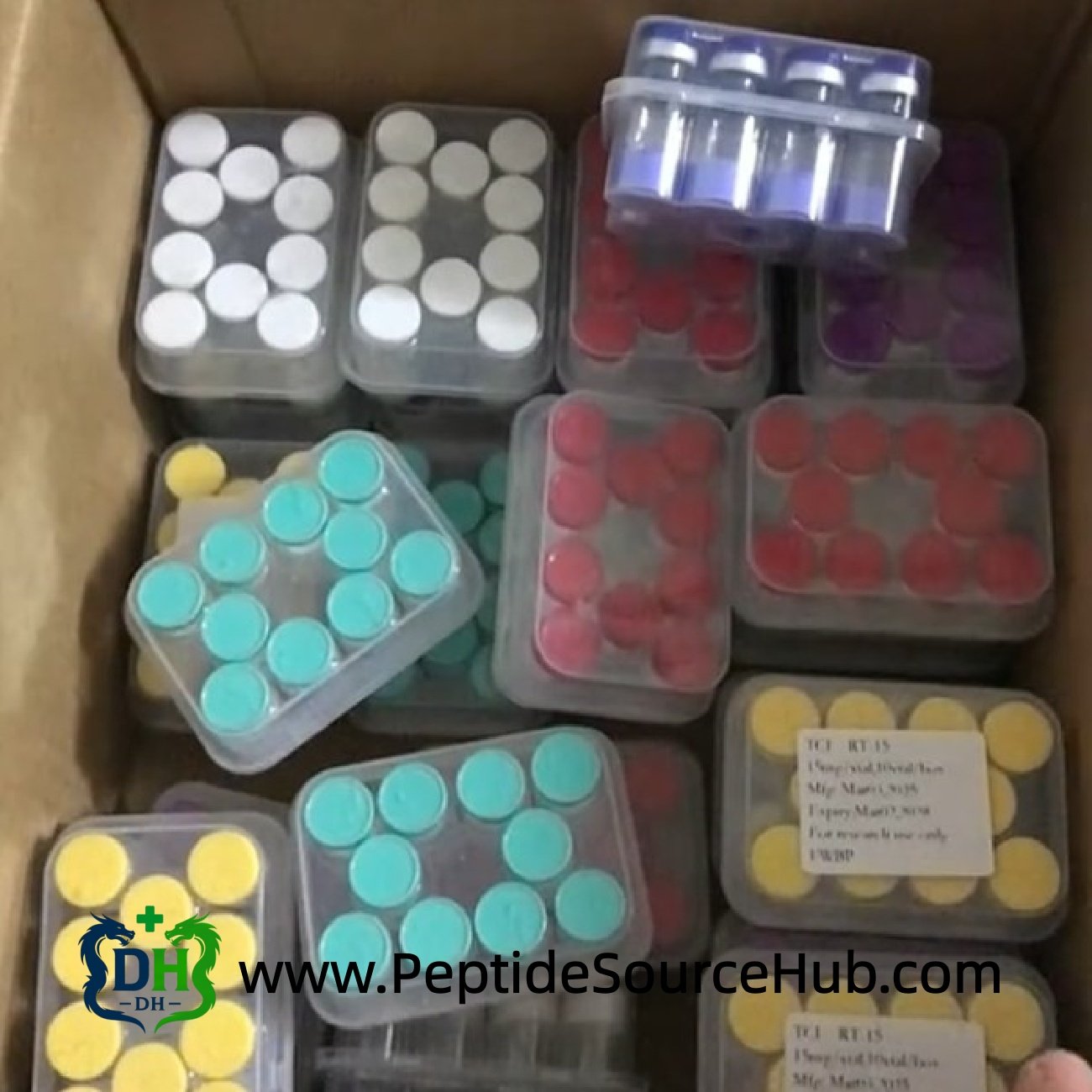Carton filled with assorted peptide trays including blue copper vials