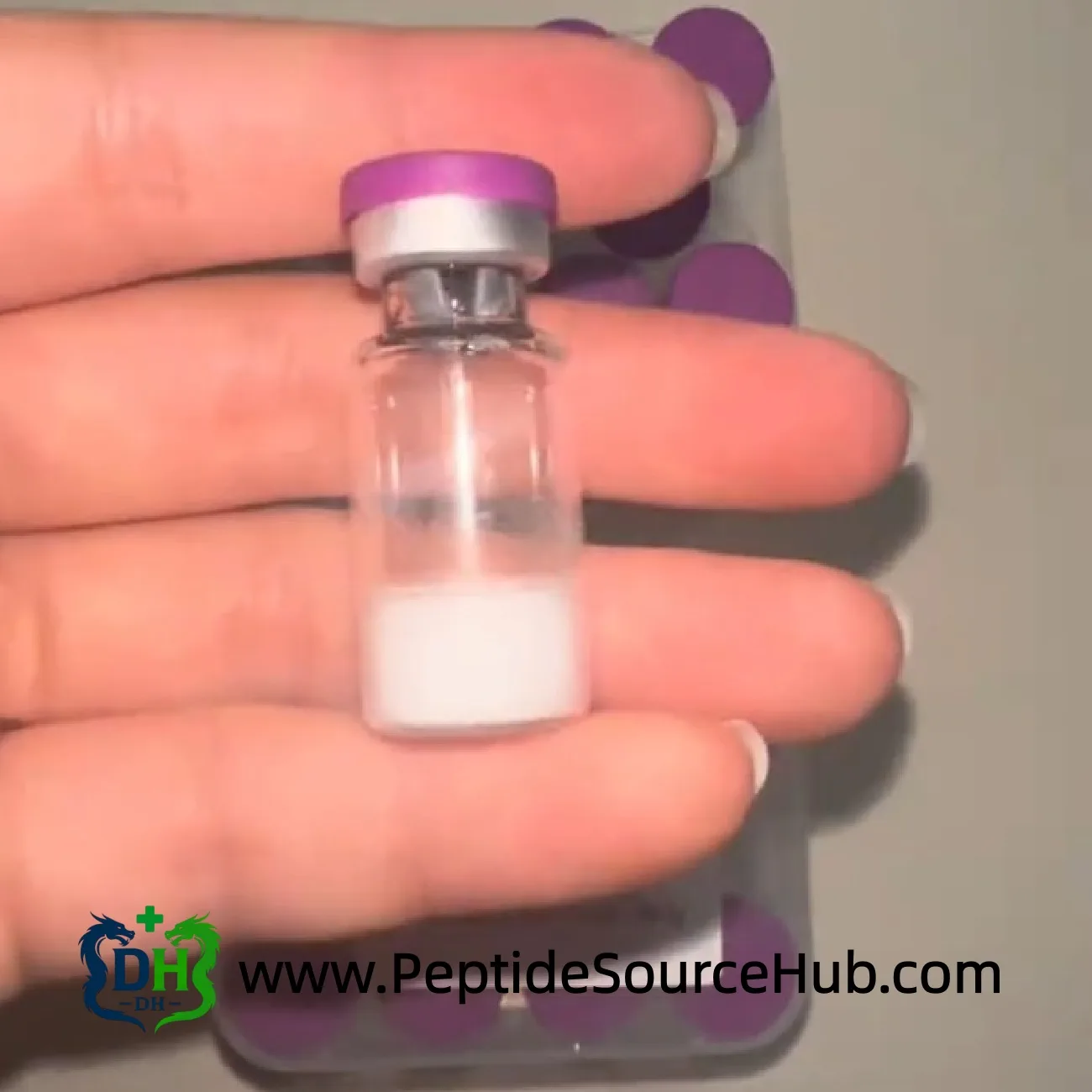 Single Tesamorelin vial with purple cap in hand