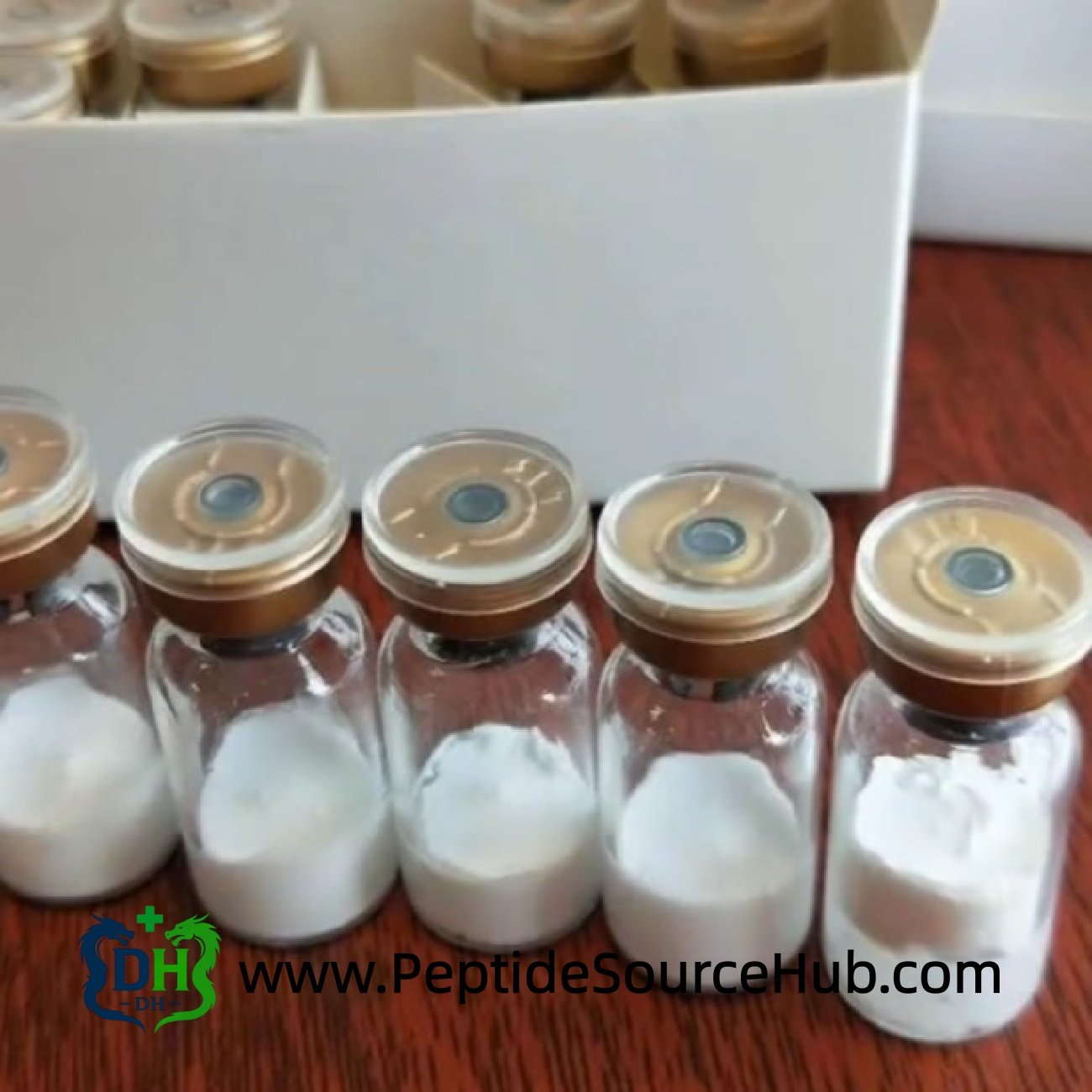 Row of bronze cap peptide vials on wooden table