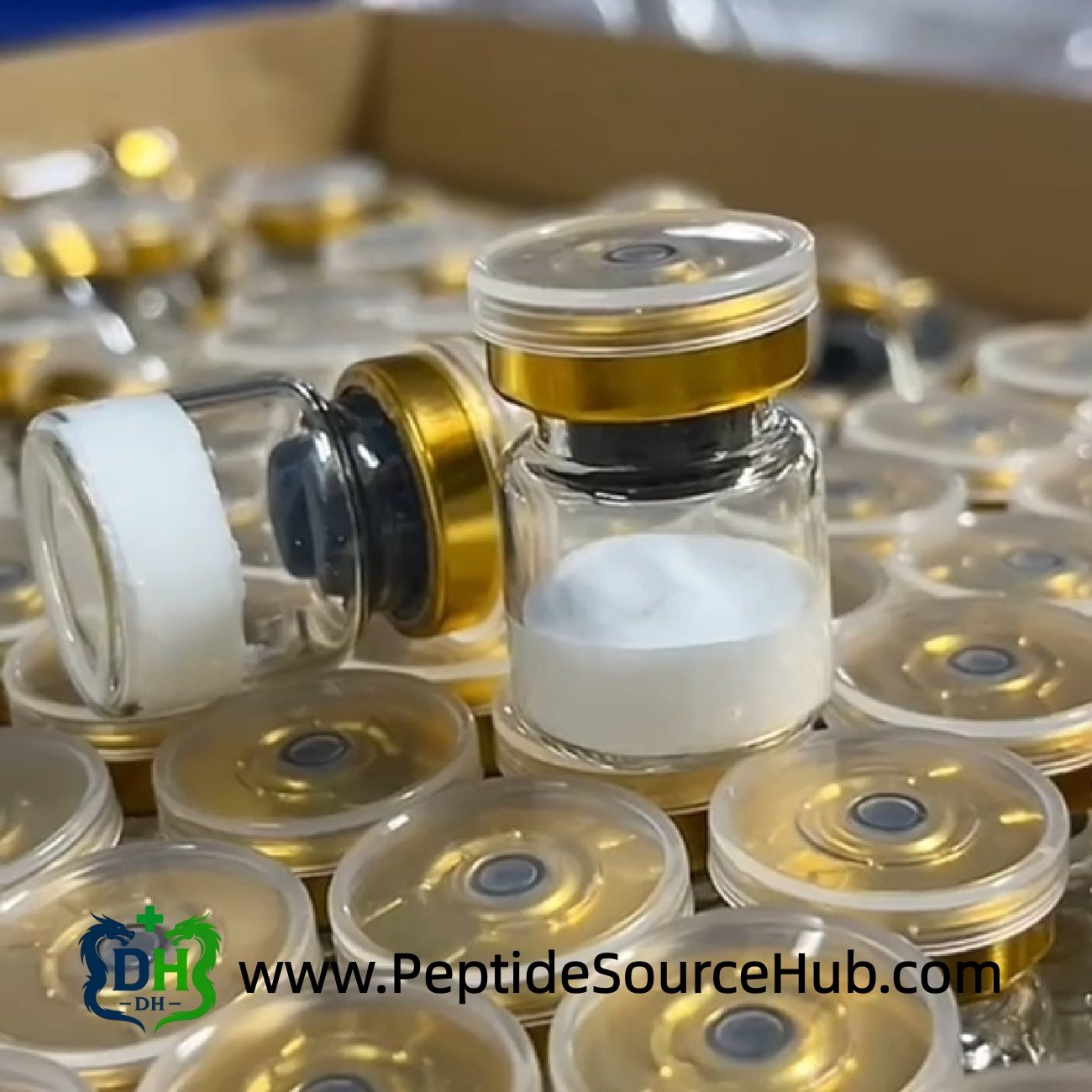 Peptide vial lying sideways beside upright vial on tray