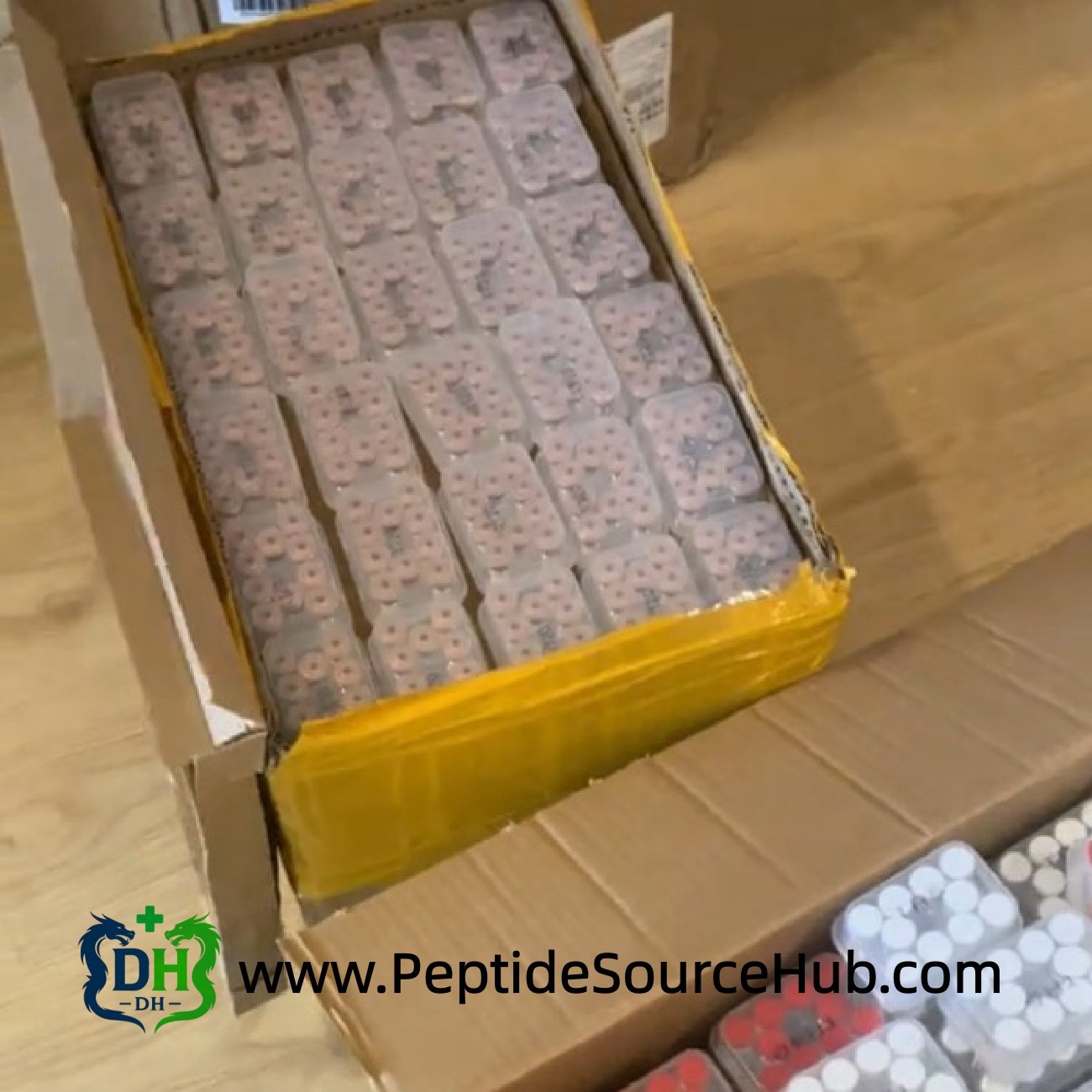 Shipping carton filled with multiple trays of peptide vials